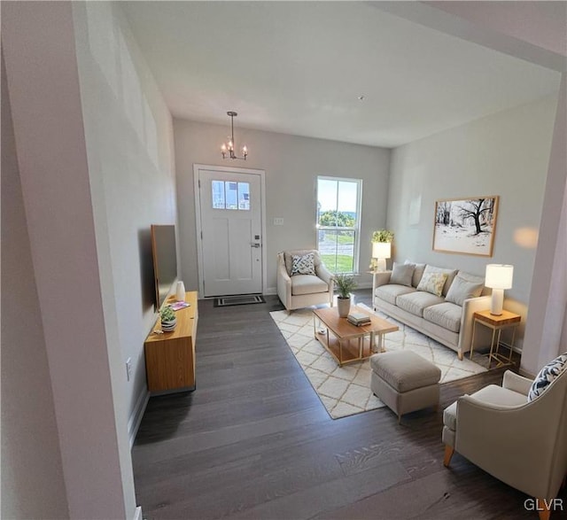 living room with wood-type flooring and a notable chandelier