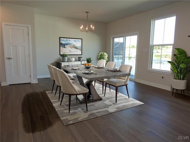 dining area with an inviting chandelier and dark hardwood / wood-style flooring