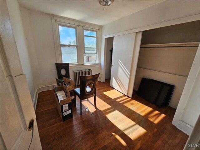 sitting room featuring radiator heating unit and dark hardwood / wood-style floors