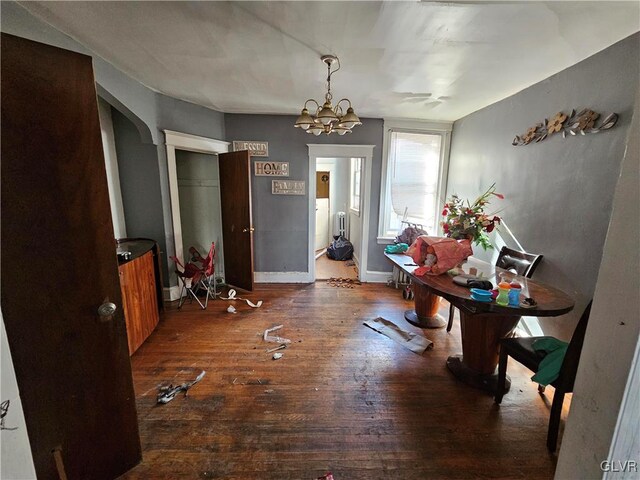 interior space featuring a notable chandelier and dark wood-type flooring