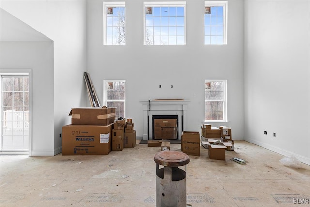 unfurnished living room featuring a high ceiling