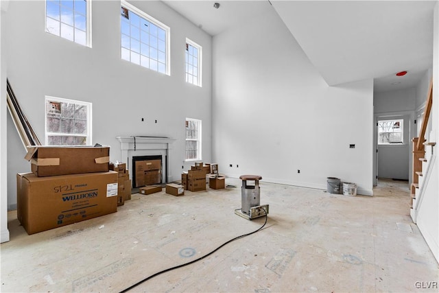 living room with a towering ceiling and a wealth of natural light