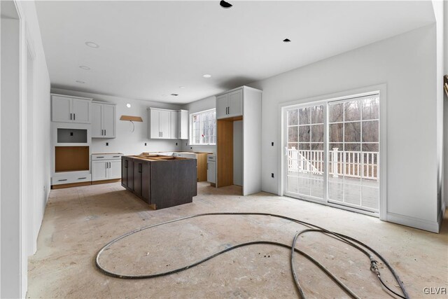 kitchen with dark brown cabinetry, white cabinetry, and a center island