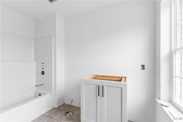 bathroom featuring tile patterned floors and shower / washtub combination