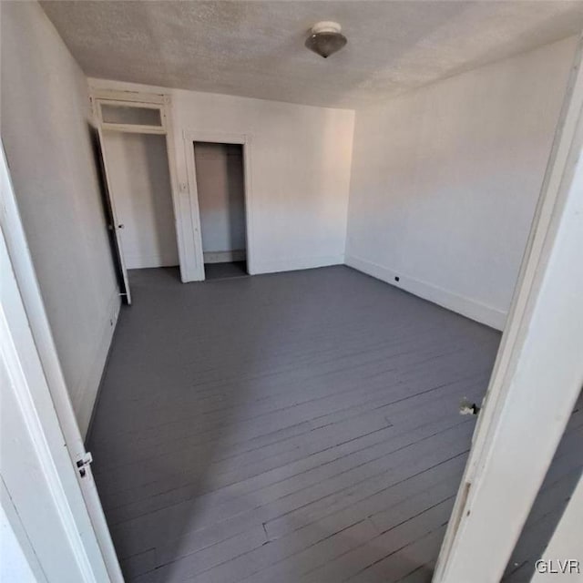 unfurnished bedroom featuring hardwood / wood-style floors and a textured ceiling