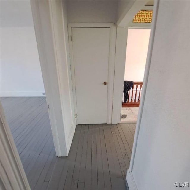 hallway with hardwood / wood-style floors