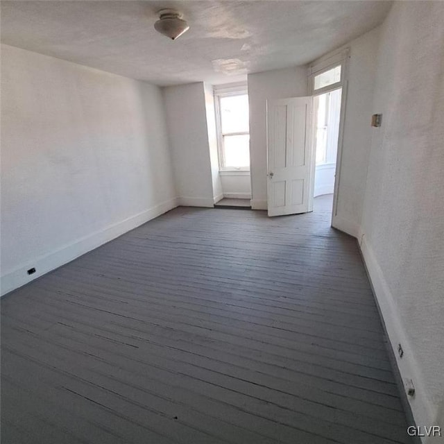 empty room featuring dark hardwood / wood-style flooring