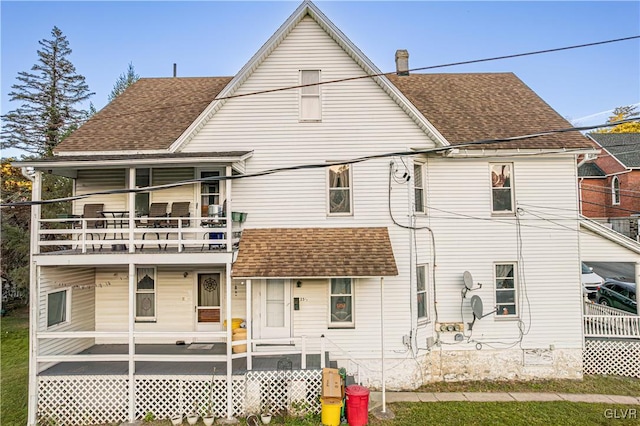 back of property featuring a balcony