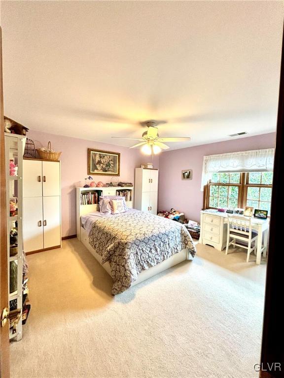 bedroom featuring light carpet and ceiling fan