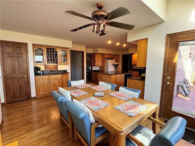 dining room with hardwood / wood-style flooring, ceiling fan, and sink