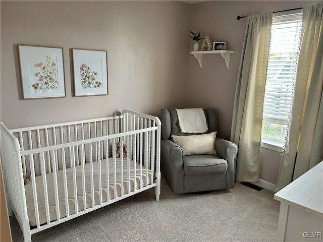 bedroom featuring carpet, multiple windows, and a nursery area