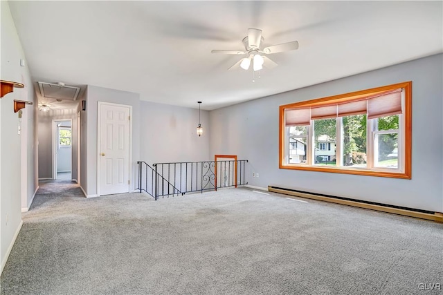 carpeted empty room with a healthy amount of sunlight, a baseboard radiator, and ceiling fan