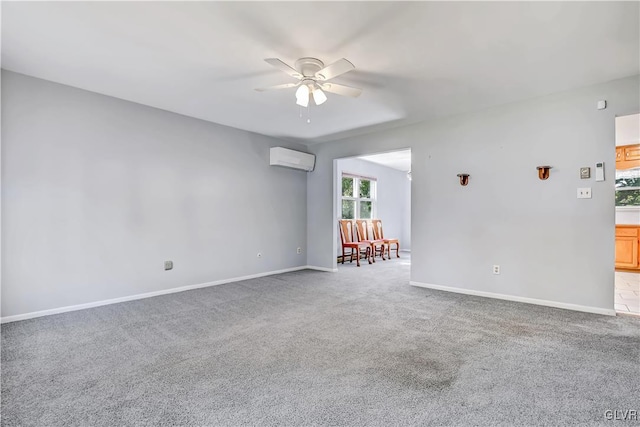 carpeted spare room featuring ceiling fan and an AC wall unit