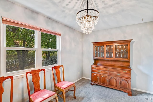 living area featuring a wealth of natural light, a chandelier, and light colored carpet