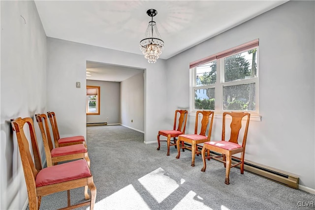 sitting room featuring an inviting chandelier, light colored carpet, and a baseboard radiator