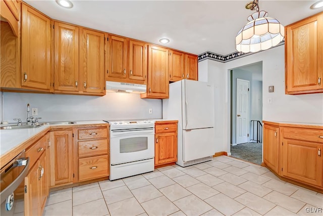 kitchen with white appliances, sink, and hanging light fixtures