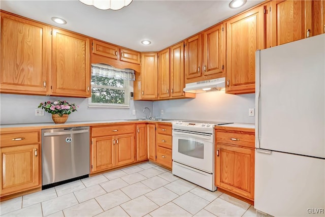 kitchen featuring light tile patterned flooring, sink, and white appliances