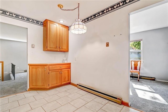 kitchen with light carpet, a baseboard heating unit, and decorative light fixtures