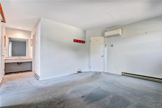 spare room with a wall mounted AC, baseboard heating, and light colored carpet