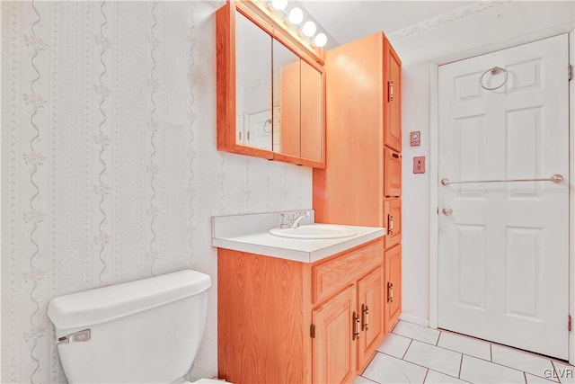 bathroom with vanity, toilet, and tile patterned floors