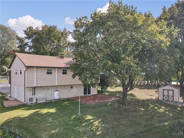 back of house with ac unit, a storage shed, a yard, and a patio