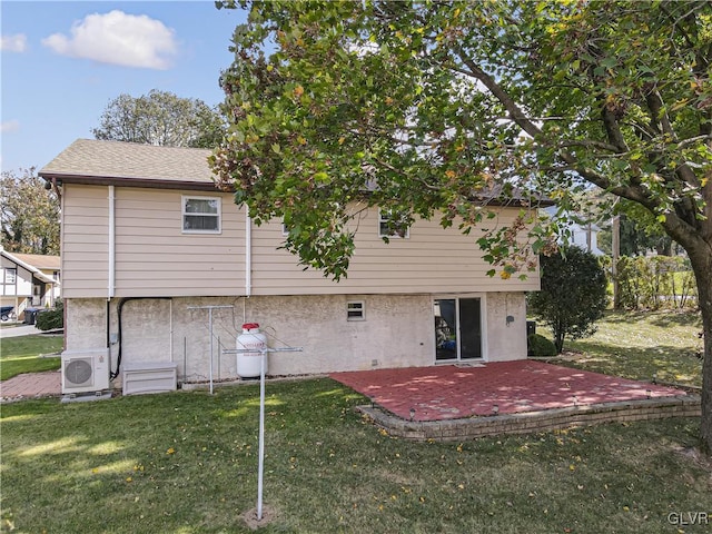 rear view of house with ac unit, a patio area, and a lawn