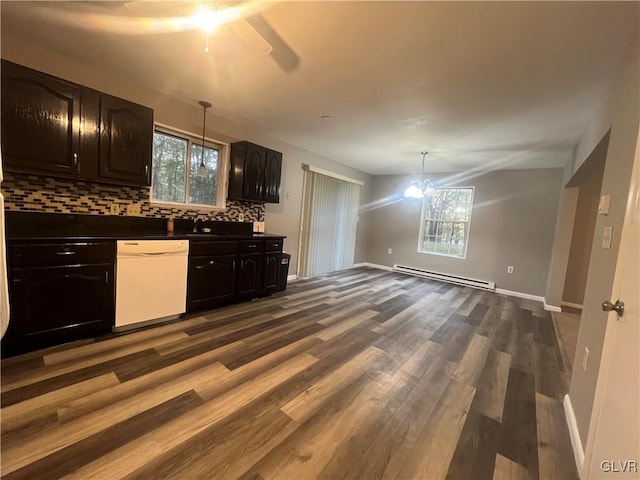 kitchen featuring decorative backsplash, baseboard heating, decorative light fixtures, and white dishwasher