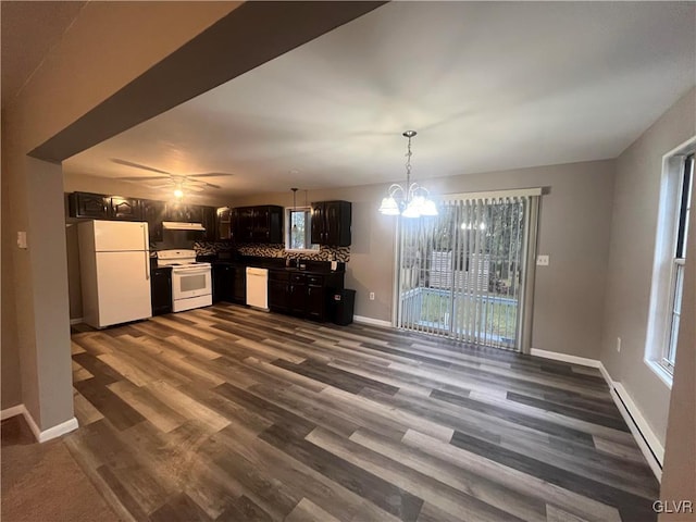 kitchen featuring dark hardwood / wood-style floors, baseboard heating, white appliances, ceiling fan with notable chandelier, and tasteful backsplash