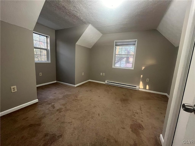 bonus room with baseboard heating, lofted ceiling, a textured ceiling, and a wealth of natural light