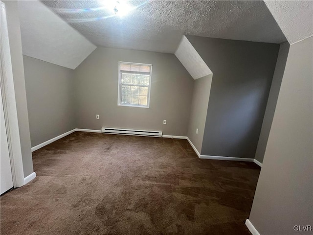 additional living space with lofted ceiling, a textured ceiling, a baseboard radiator, and dark colored carpet