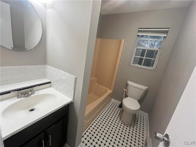 bathroom featuring vanity, tasteful backsplash, toilet, and tile patterned flooring