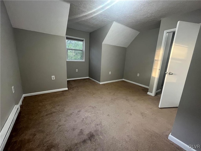 additional living space featuring light carpet, a textured ceiling, vaulted ceiling, and baseboard heating