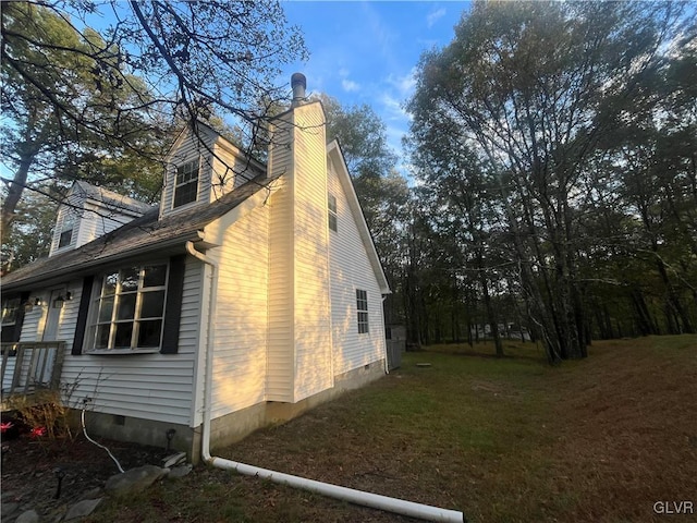 view of side of home featuring a lawn