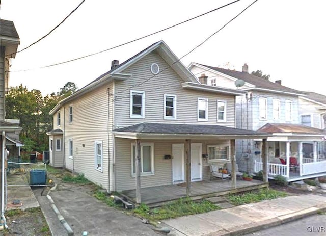 view of property featuring covered porch