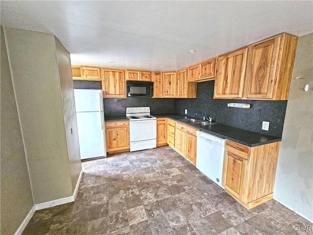 kitchen with decorative backsplash, white appliances, and sink