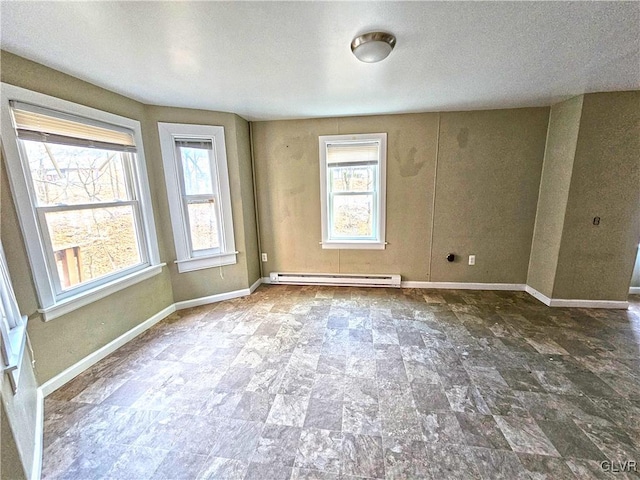 empty room with a textured ceiling and a baseboard radiator