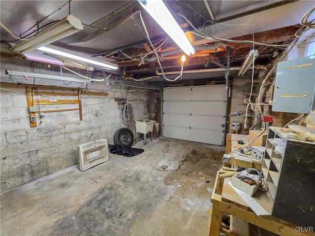 garage featuring sink and electric panel