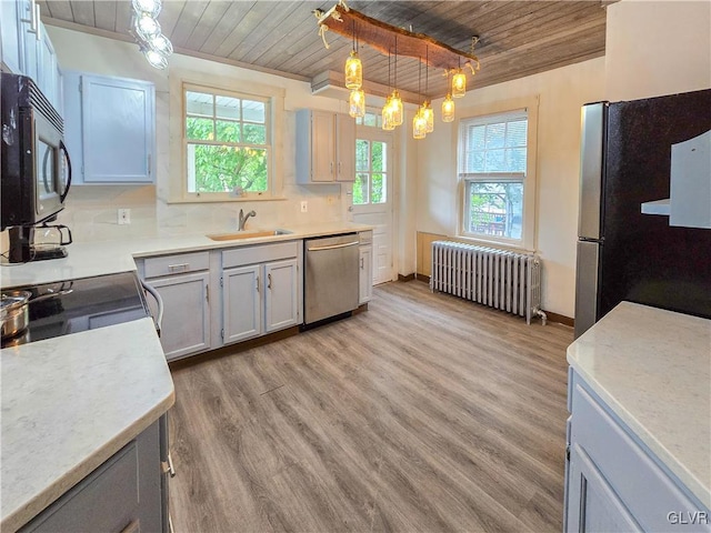 kitchen with radiator, stainless steel appliances, wooden ceiling, pendant lighting, and decorative backsplash