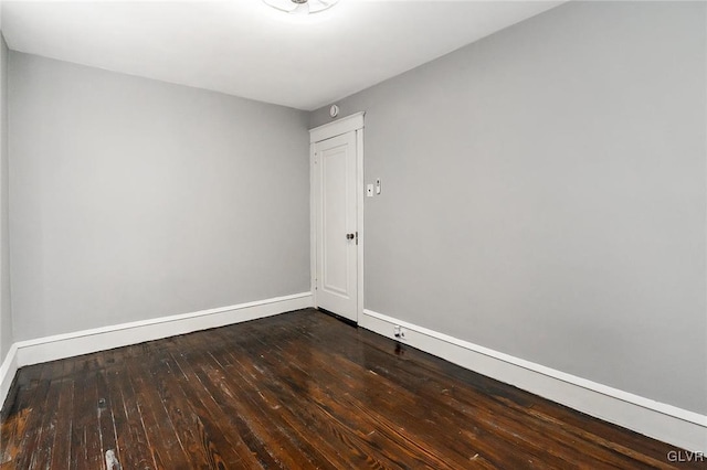 unfurnished room featuring dark wood-type flooring