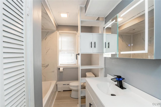 full bathroom featuring a baseboard heating unit, shower with separate bathtub, toilet, hardwood / wood-style flooring, and vanity