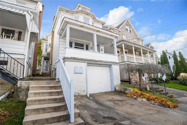 view of front of property with a garage and a balcony