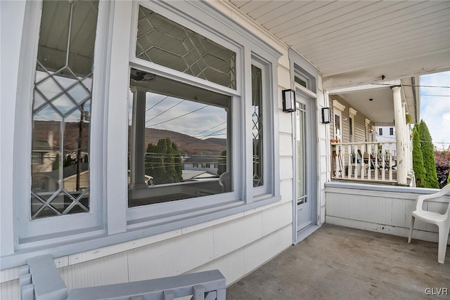 view of exterior entry featuring covered porch