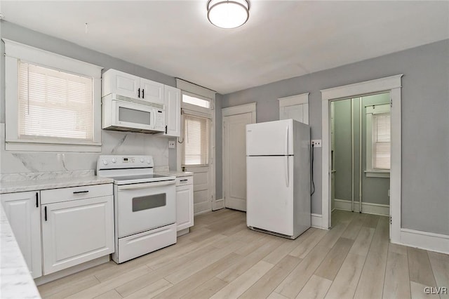 kitchen featuring white cabinetry, white appliances, and light hardwood / wood-style flooring