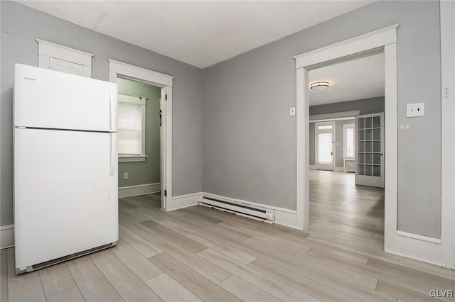 kitchen featuring light hardwood / wood-style flooring, white refrigerator, french doors, and a baseboard radiator