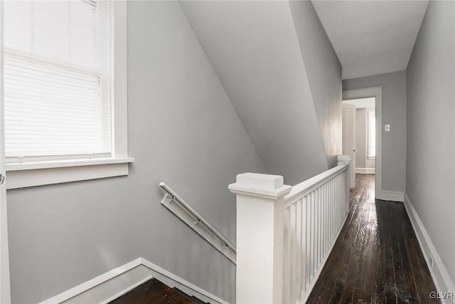 hall with hardwood / wood-style floors and vaulted ceiling