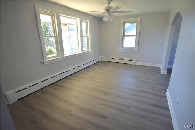 unfurnished room with light hardwood / wood-style flooring, a baseboard radiator, and ceiling fan