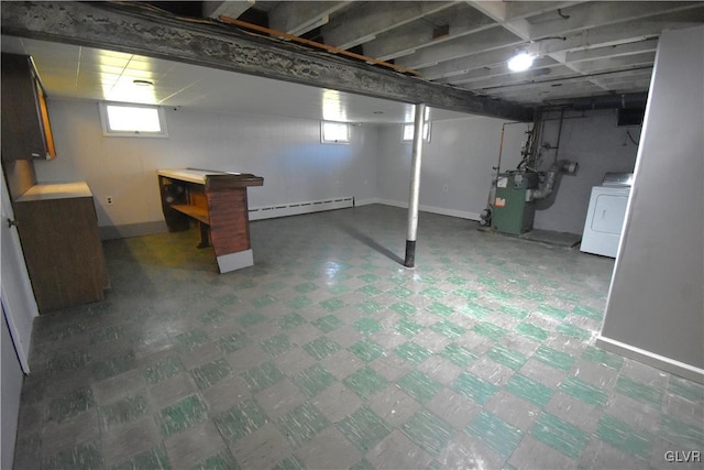 basement featuring washer / clothes dryer, baseboard heating, and plenty of natural light