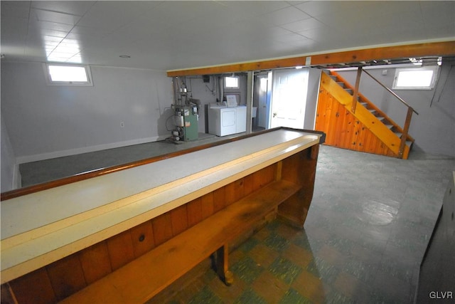 bar featuring washing machine and dryer and a wealth of natural light