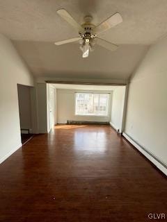 spare room with lofted ceiling, dark hardwood / wood-style floors, and ceiling fan