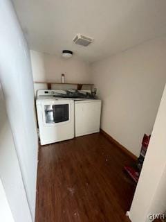 washroom with washer and dryer and dark hardwood / wood-style flooring